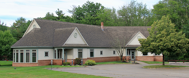 office exterior with trees and parking lot